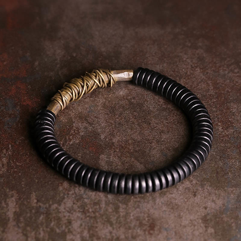 Buddha Stonesの穏やかなチベット黒檀と銅のブレスレット