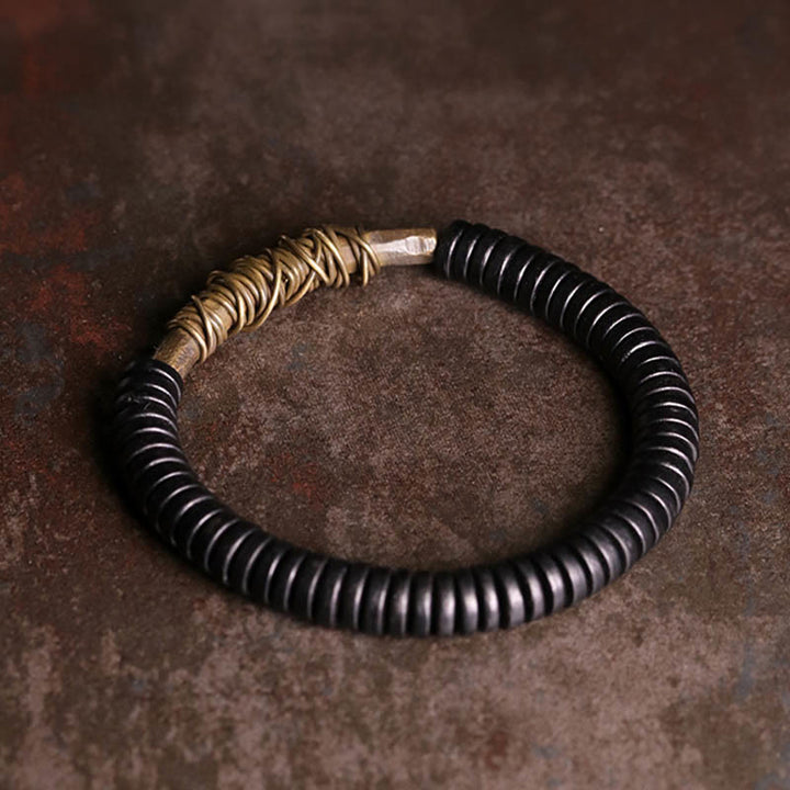Buddha Stonesの穏やかなチベット黒檀と銅のブレスレット