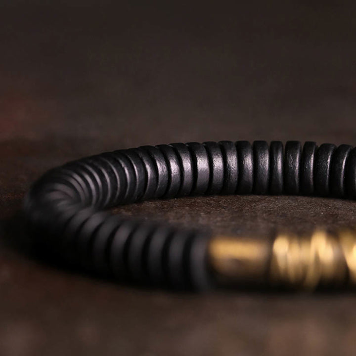Buddha Stonesの穏やかなチベット黒檀と銅のブレスレット