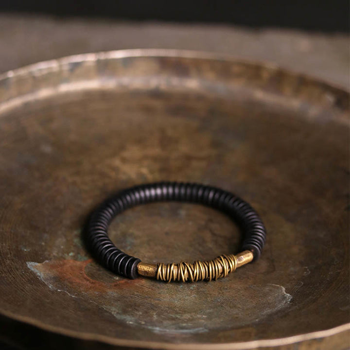 Buddha Stonesの穏やかなチベット黒檀と銅のブレスレット