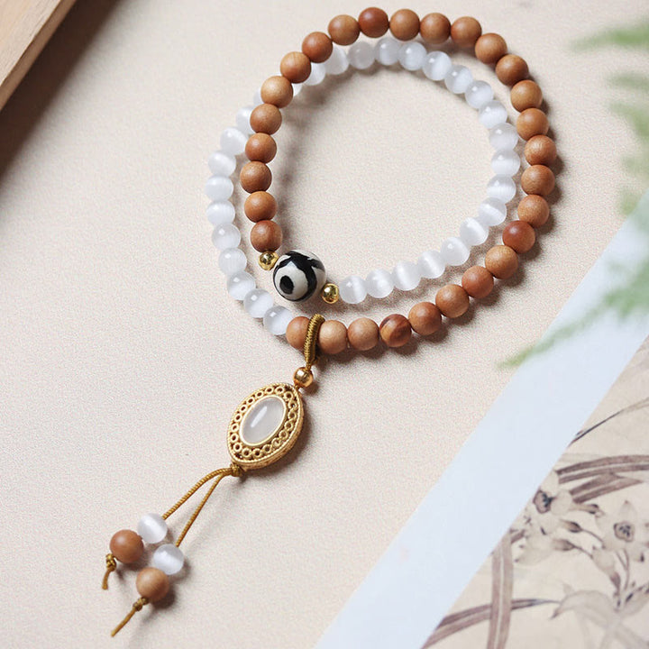 Buddha Stonesサンダルウッドキャッツアイ三眼ビーズクリスタルプロテクションブレスレット
