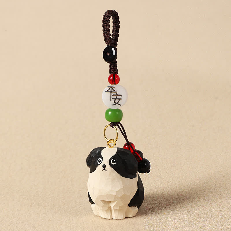 Buddha Stones 木彫りの犬オーム・マニ・パドメ・フム知恵のキーホルダー - 安全な白黒の犬 - image 1