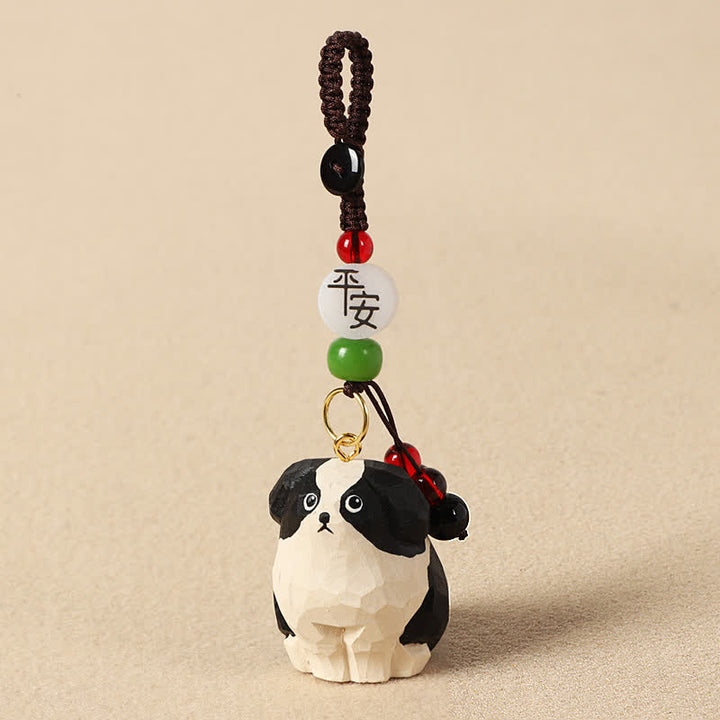 Buddha Stones 木彫りの犬オーム・マニ・パドメ・フム知恵のキーホルダー - 安全な白黒の犬 - image 1