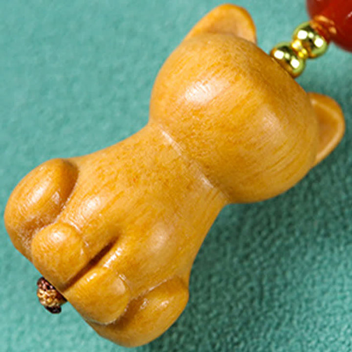 Buddha Stones 手彫りの白檀製猫魚浄化キーホルダー - image 3