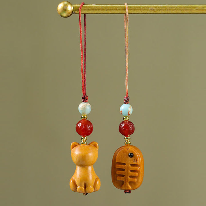 Buddha Stones 手彫りの白檀製猫魚浄化キーホルダー - image 0