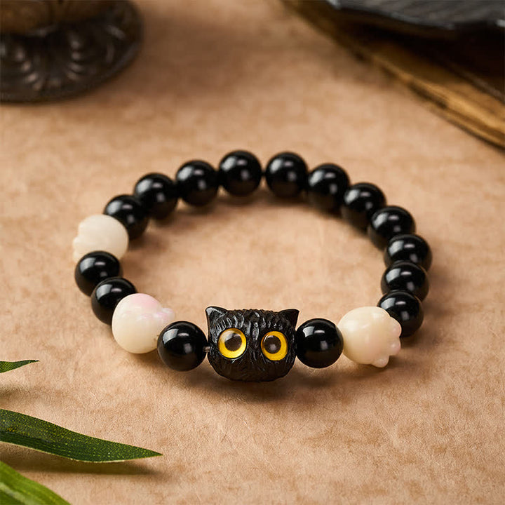 Buddha Stones 手彫りの黒曜石製、黄色い目の猫の頭をモチーフにしたグラウンディングビーズブレスレット - image 1