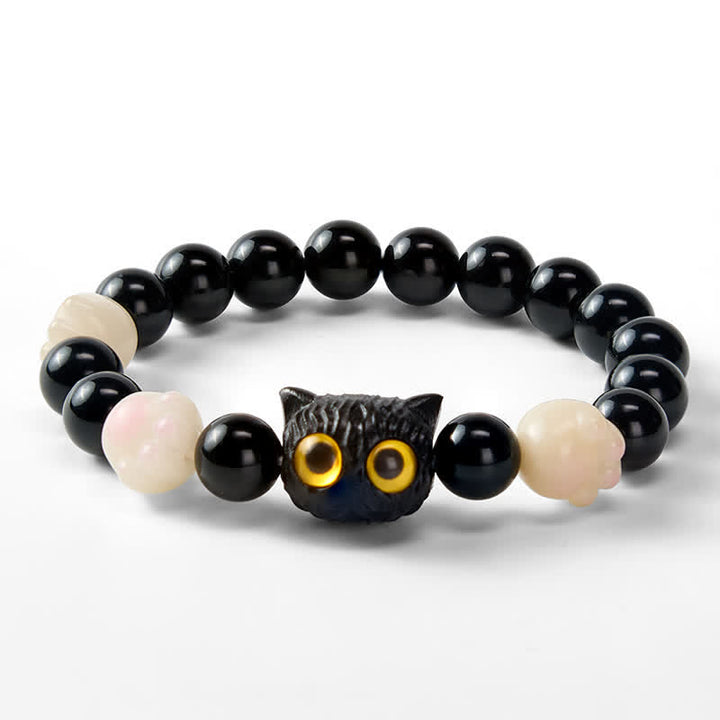 Buddha Stones 手彫りの黒曜石製、黄色い目の猫の頭をモチーフにしたグラウンディングビーズブレスレット - image 3