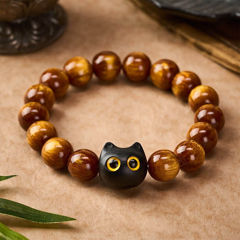 Buddha Stones 黄色の樹脂ビーズ、黄色の目、黒檀猫モチーフの落ち着いたブレスレット - image 1