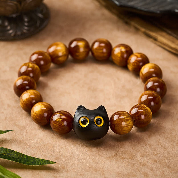 Buddha Stones 黄色の樹脂ビーズ、黄色の目、黒檀猫モチーフの落ち着いたブレスレット - image 1
