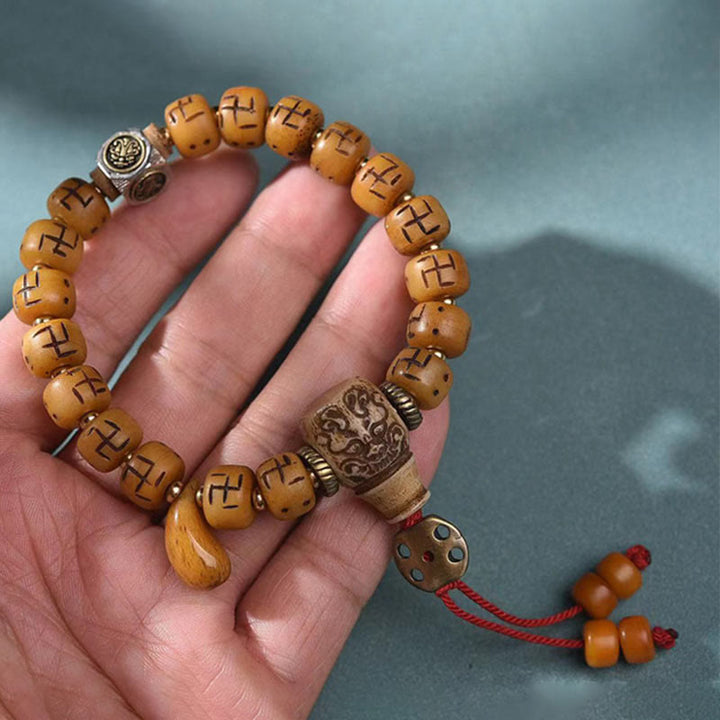 Buddha Stones天然チベットラクダ骨卍 Dzi ビーズ Shankha 仏陀チャーム Kirtimukha 幸運保護タッセルブレスレット