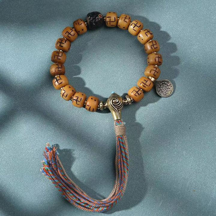 Buddha Stones天然チベットラクダ骨卍 Dzi ビーズ Shankha 仏陀チャーム Kirtimukha 幸運保護タッセルブレスレット