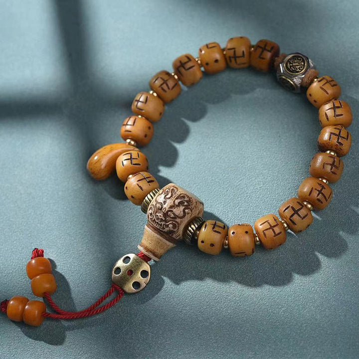 Buddha Stones天然チベットラクダ骨卍 Dzi ビーズ Shankha 仏陀チャーム Kirtimukha 幸運保護タッセルブレスレット