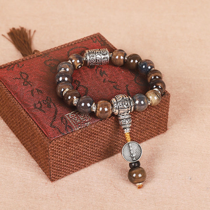 チベットのBuddha Stones、オーム・マニ・パドメ・フムの祈祷ホイール、ドルジェ・ヴァジュラの彫刻入りガラスビーズの知恵のブレスレット