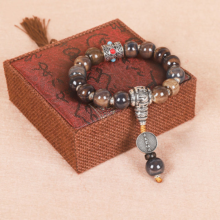 チベットのBuddha Stones、オーム・マニ・パドメ・フムの祈祷ホイール、ドルジェ・ヴァジュラの彫刻入りガラスビーズの知恵のブレスレット